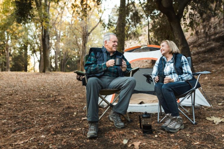 Senior couple enjoy their retirement camping in a park