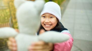 Child with valuable beanie baby toy