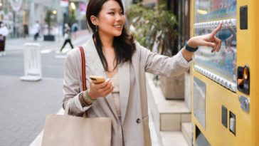 Woman using weird vending machine in Japan