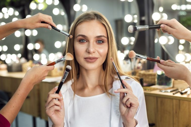 Wealthy woman having expensive makeup applied to her face