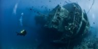 Diver forages lead from sunken ship for science experiments
