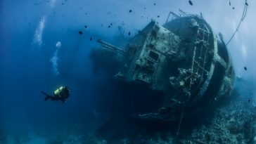 Diver forages lead from sunken ship for science experiments