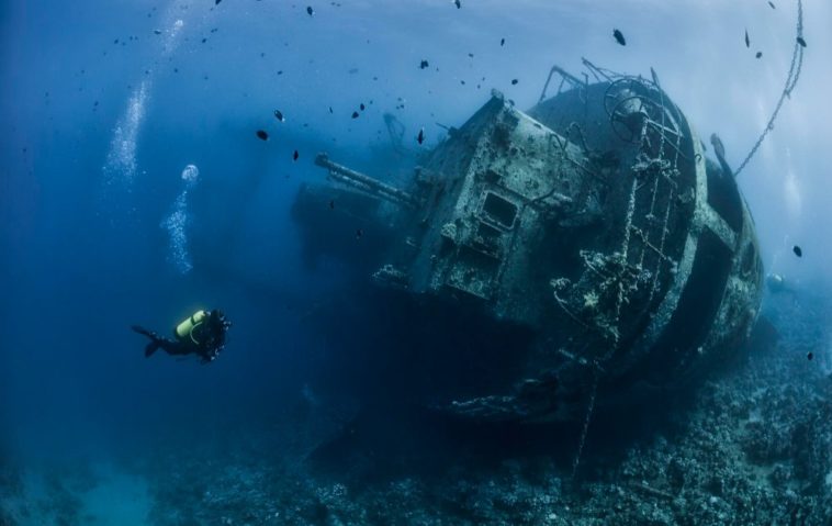 Diver forages lead from sunken ship for science experiments