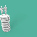 two people standing on top of a stack of coins