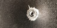 bullet stuck in metal sheet
