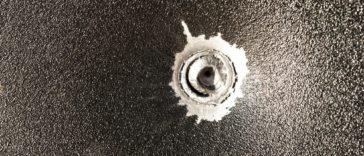 bullet stuck in metal sheet