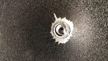 bullet stuck in metal sheet