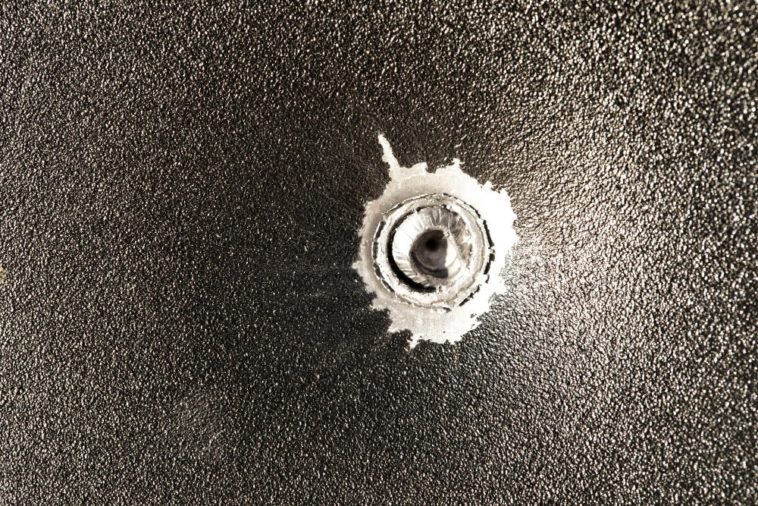 bullet stuck in metal sheet