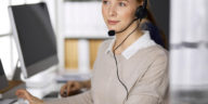 woman at a computer talking on a headset