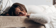 woman sleeping with a phone next to her bed