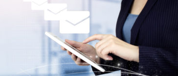woman sending emails on a touch screen device