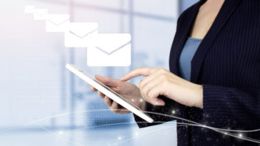 woman sending emails on a touch screen device