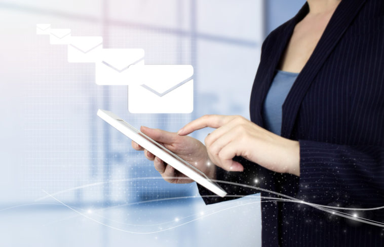 woman sending emails on a touch screen device