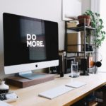 computer on desk with do more written onscreen