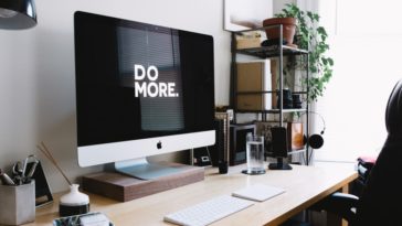 computer on desk with do more written onscreen