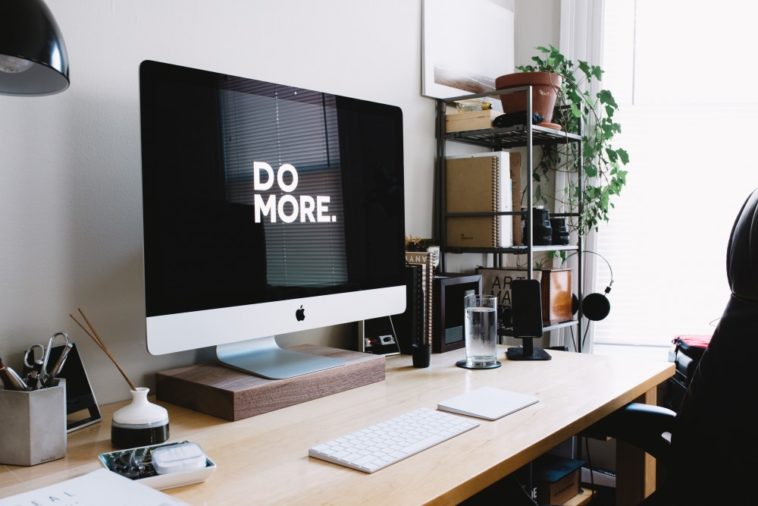 computer on desk with do more written onscreen