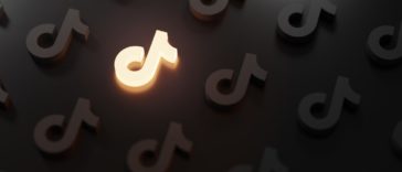 tiktok logo pattern with one glowing icon