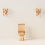 gold toilet bowl in front of a cream color wall