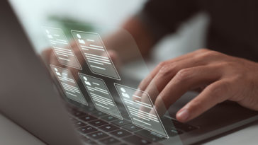 person typing looking at resumes on a virtual screen