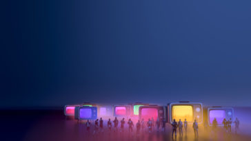 people standing in front of big colorful televisions