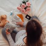 pregnant woman folding baby clothes