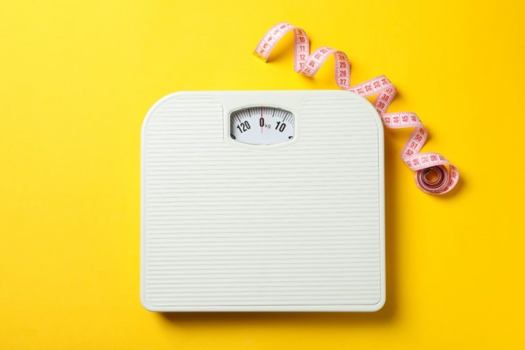 a scale and a measuring tape with a yellow background