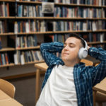 student listening to an audiobook in a library