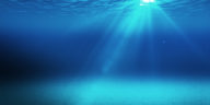 blue underwater space with light going through the surface