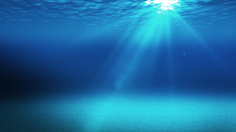 blue underwater space with light going through the surface