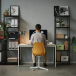 back view of a man using a computer in a home office