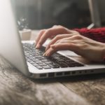 woman hands typing on a laptop