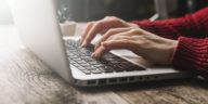 woman hands typing on a laptop