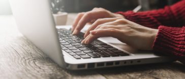 woman hands typing on a laptop