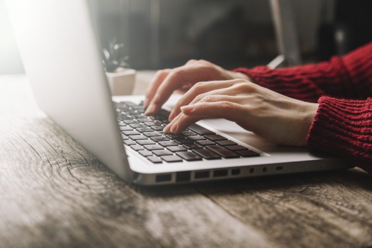 woman hands typing on a laptop