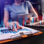 woman working in a modern office with a graph indicator