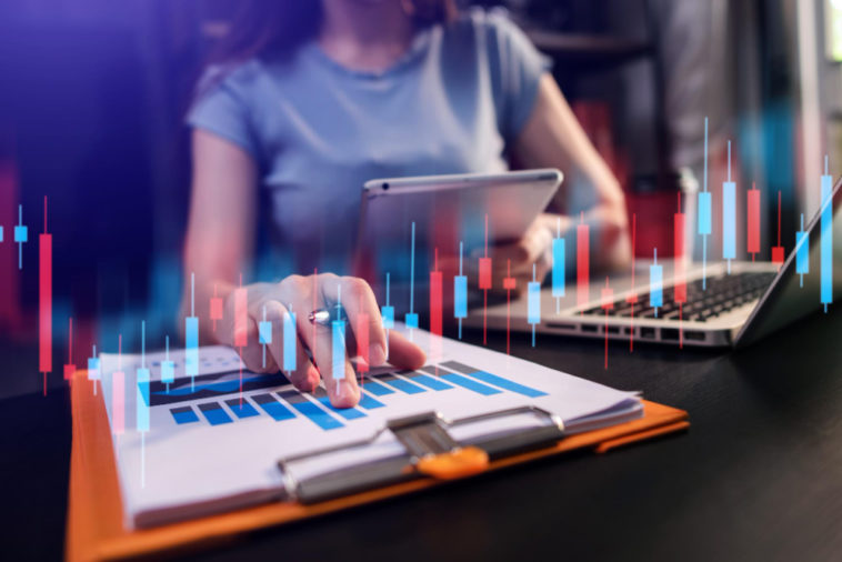 woman working in a modern office with a graph indicator