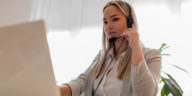 woman sitting in front of a laptop with headphones