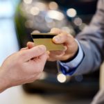 two people exchanging a debit card