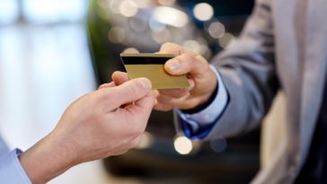 two people exchanging a debit card