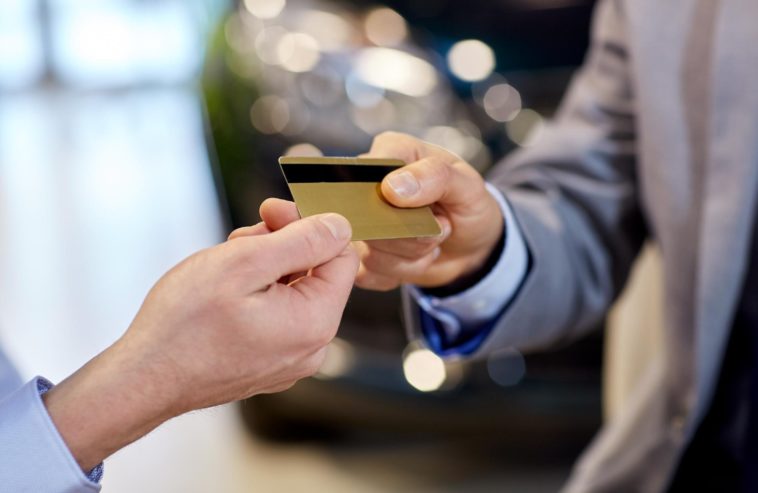 two people exchanging a debit card