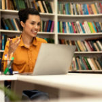 woman in a library having a video call