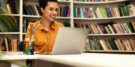 woman in a library having a video call