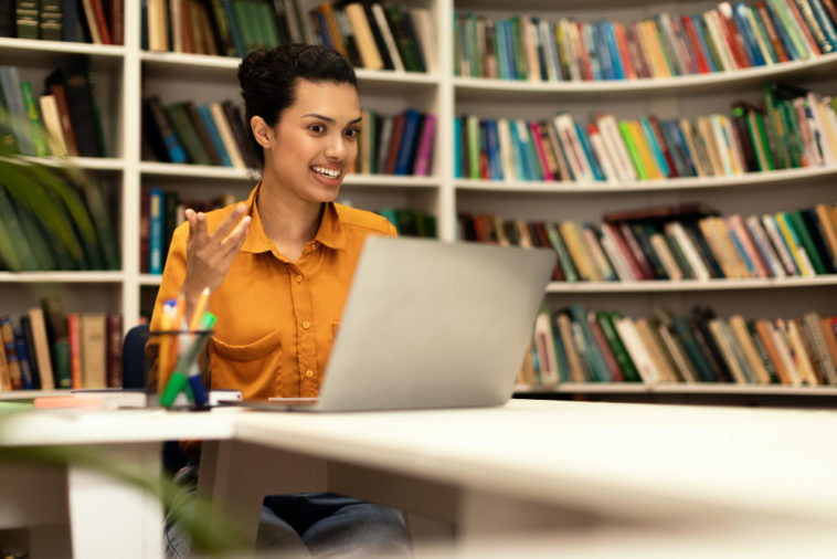 woman in a library having a video call