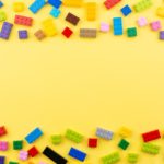 colored toy bricks on a yellow background