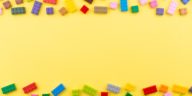 colored toy bricks on a yellow background