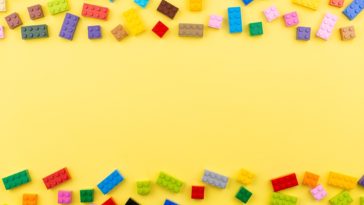 colored toy bricks on a yellow background