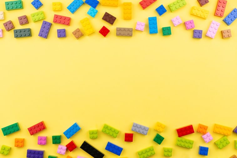 colored toy bricks on a yellow background