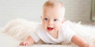 cute happy baby with an all white surrounding