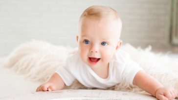 cute happy baby with an all white surrounding