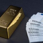a gold bar and a stack of euros
